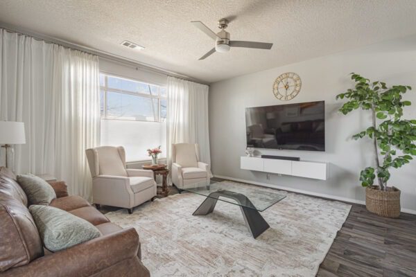 Modern living room with TV and seating.
