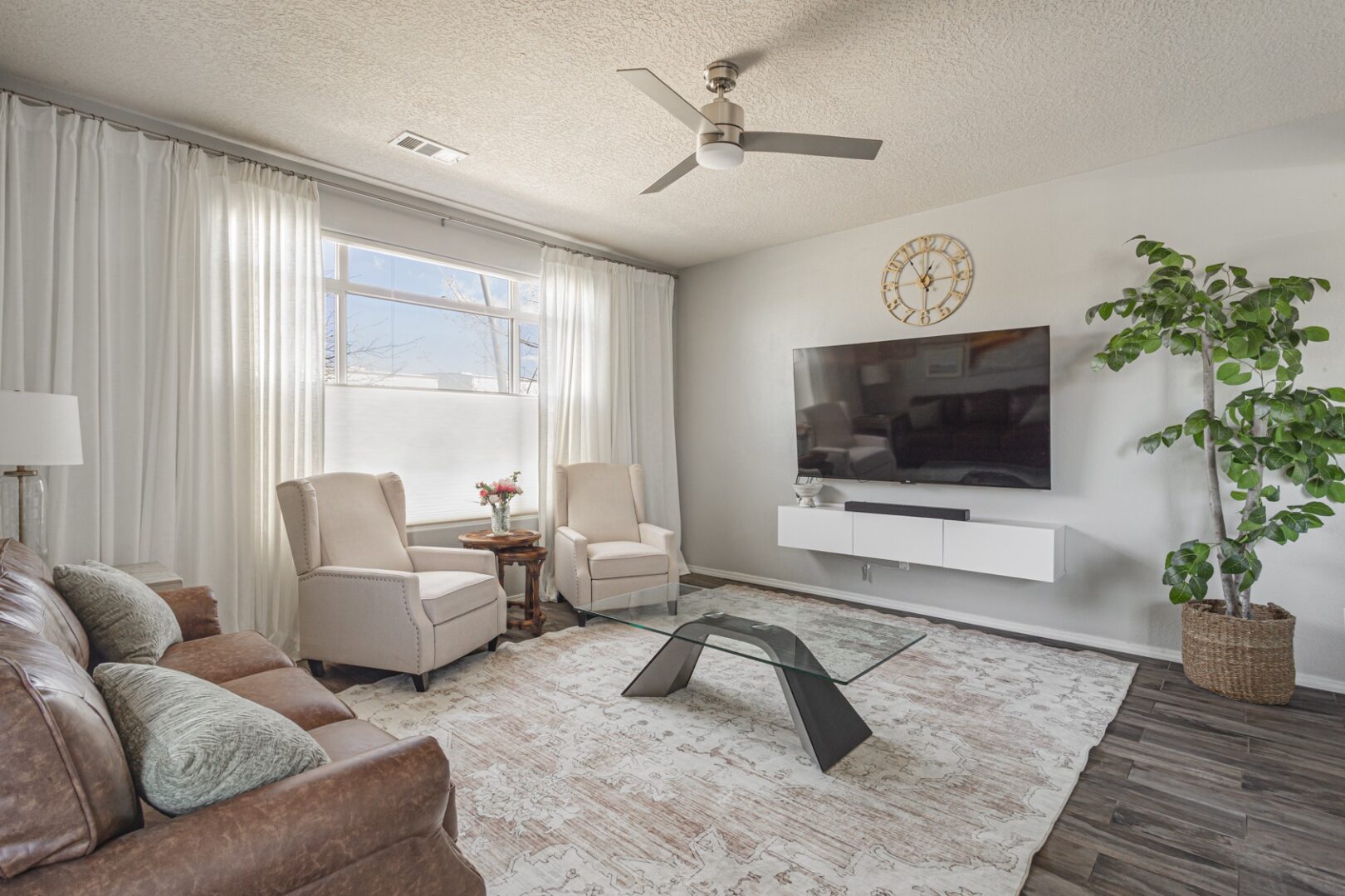 Modern living room with TV and seating.